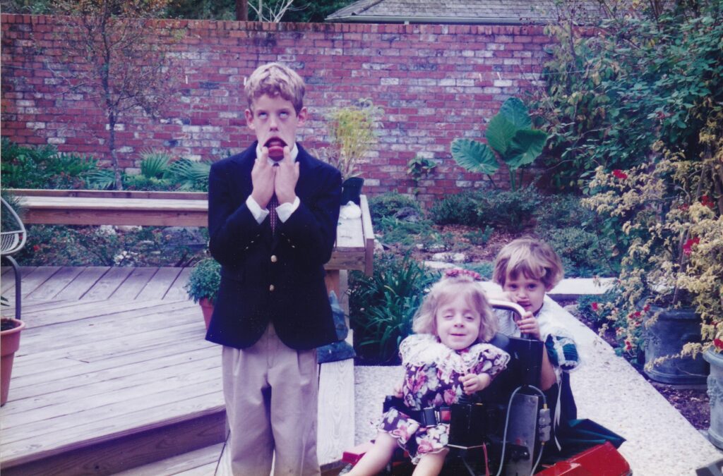 Young children playing outdoors in a garden setting.